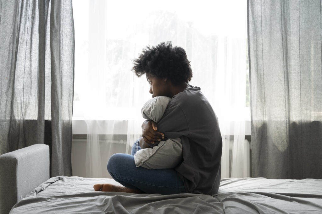 "Woman reflecting on childhood trauma signs, and healing"