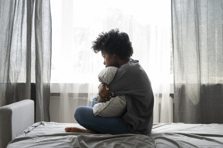 "Woman reflecting on childhood trauma signs, and healing"